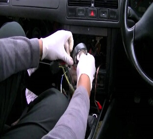 Auto Electrician fitting an in-car Radio